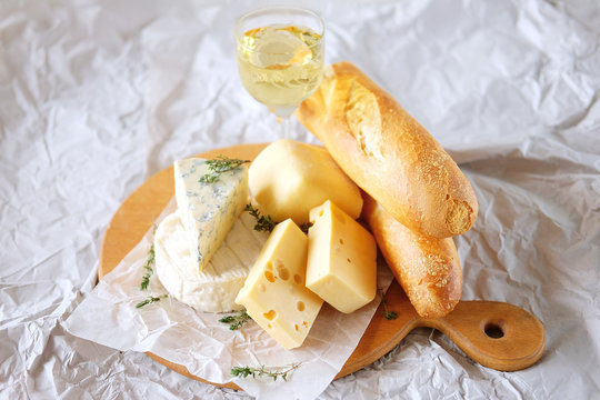 Cheese plate with different kinds of cheese with white wine