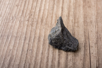 little gold color stone on a wooden background