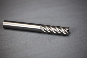 Isolated image of 6 flute end mill with gray background