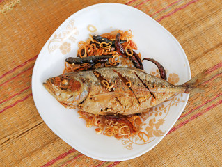 Mackerel fried in in dish with onion and chili, Frying fish