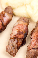Grilled kebabs in bacon with mashed potatoes
