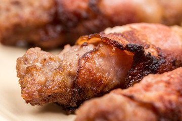 Closeup macro kebabs grilled in bacon