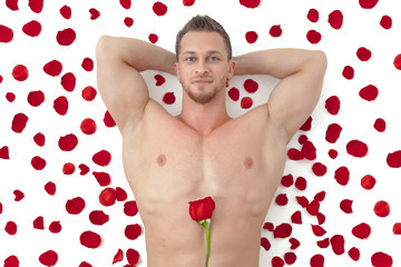 Obraz na płótnie Canvas Wet nude muscular man with a rose