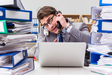 Busy businessman under stress due to excessive work