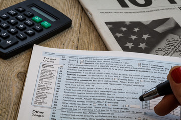 Tax preparation form US 1040 and tax tables, generic (no year specified), holding pen and...