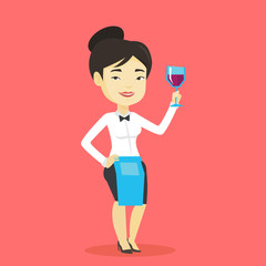 Bartender holding a glass of wine in hand.