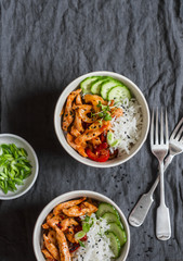 Asian style fried chicken and rice on a dark background, top view.