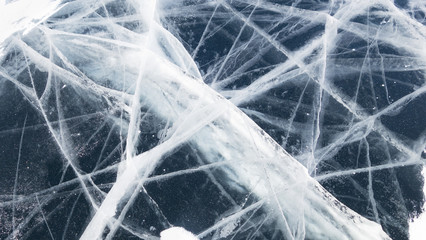 Texture of ice of Baikal lake in Siberia. Dark blue ice surface pattern. ice and cracks on the surface of Lake Baikal