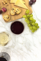 Wine tasting with bread, grapes, cheese, and copyspace