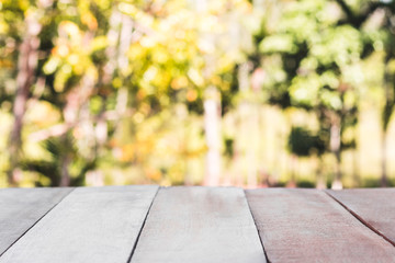 table  and sunlight with blurred trees  background, empty wooden table for product display