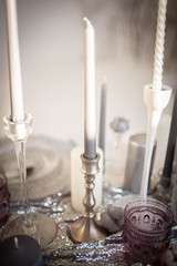 Long candles in candlesticks. Beautiful decorations.