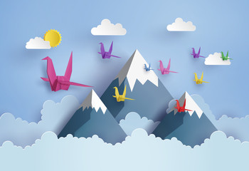 origami made colorful paper bird flying on blue sky - obrazy, fototapety, plakaty