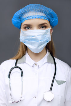 
Face of woman  doctor, nurse  in mask  with stethoscope. Close up 
