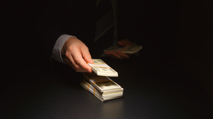 BRIBE: Businessman counts and puts down a heap money on a table