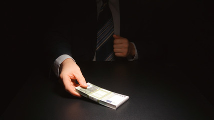 BRIBE: Businessman takes out a money from a pocket of a suit (EURO)