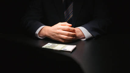 BRIBE: Businessman waits and puts a money on a table (EURO) - Two person