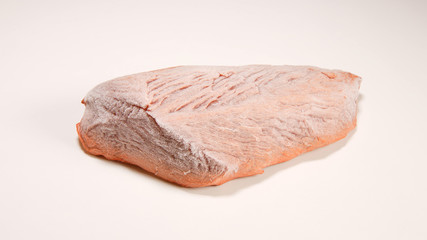 Frozen beef steak on white table