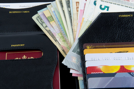 Photo set for the traveller: purse, credit cards, passports and money from different countries