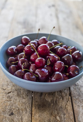 Red cherries in antique bowl