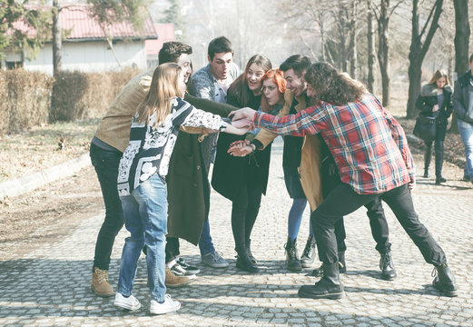 College Students Teamwork Stacking Hand Concept,young group of people are looking forward to their faces shining happiness