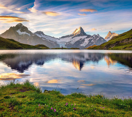 Wetterhorn and Wellhorn peaks reflected in water surface of Bachsee lake