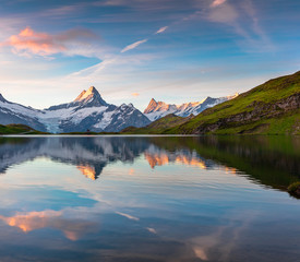 Wetterhorn peak reflected in water surface of Bachsee lake