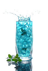 Glass of a blue alcoholic cocktail drink with ice and mint