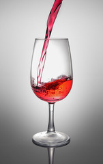 Splash of a red wine in glass