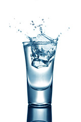 Glass of an alcoholic drink with ice. Tequila or vodka shots