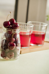 glass of fresh cherry juice and fresh cherries