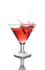 Splash in glass of a pink alcoholic cocktail drink