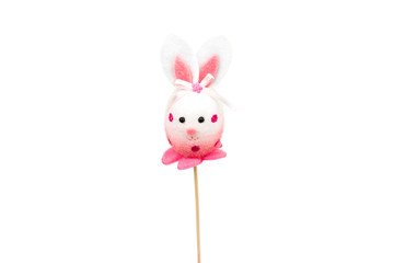 Decorative hare/ rabbit with wooden stick. Easter, spring, summer decor. Cute Interior object. Pink hare isolated on the white background. Closeup. Front view.