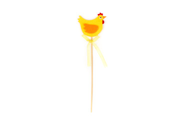 Decorative yellow hen with wooden stick. Easter decoration. Interior decor. Hen isolated on white background. 