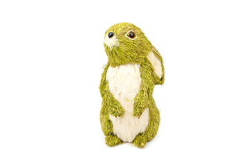 Obraz premium Decorative hare/ rabbit. Easter, spring, summer decor made from natural green, cream white straws. Cute Interior object. Hare isolated on the white background. Front view.