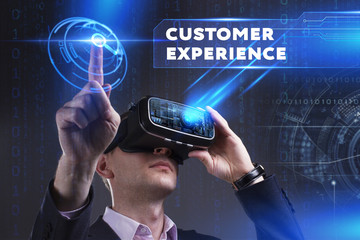 Business, Technology, Internet and network concept. Young businessman working in virtual reality glasses sees the inscription: Customer experience