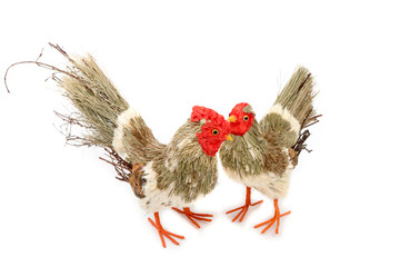 Decorative rooster and hen prepared from natural materials. Easter decoration. Interior, garden decor. Rooster prepared from branches and straws. Isolated on white background. Side view.