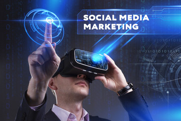 Business, Technology, Internet and network concept. Young businessman working in virtual reality glasses sees the inscription: Social media marketing