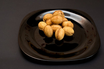 Nutlet with condensed milk On a black plate