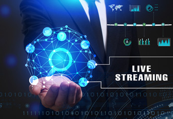 Business, Technology, Internet and network concept. Young businessman working on a virtual screen of the future and sees the inscription: Live streaming