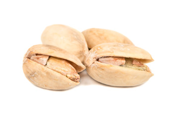 Several pistachio nuts on a white background