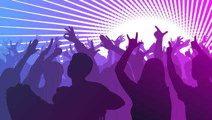 Silhouettes of dancing people in front of bright stage lights