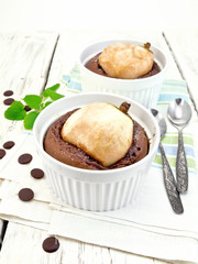 Cake chocolate with pear in white bowl on kitchen towel