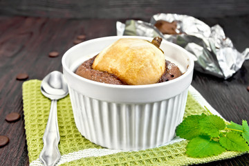 Cake chocolate with pear in white bowl on green napkin