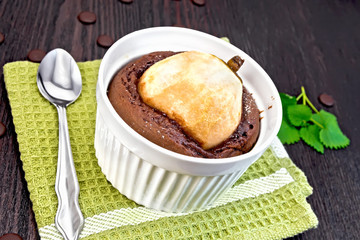 Cake chocolate with pear in white bowl on napkin