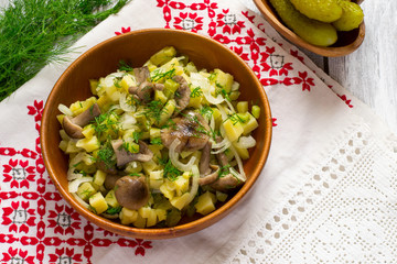 Traditional Russian village salad in a wooden bowl