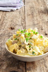 Chicken salad in a plate on a wooden background. Food Photo