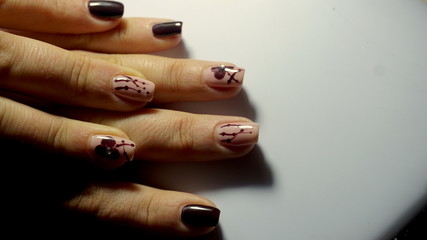 Female hand with trendy manicure. Nail design on a white background closeup