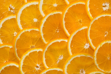 Bright orange background from slices of juicy Orange. Healthy food, background.