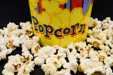 Box of fresh popcorn on black background