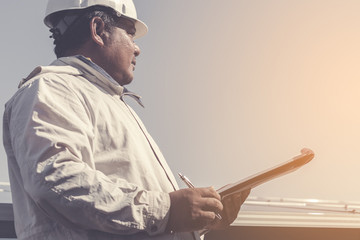 foreman checking job routine of labor working on cleaning solar panel at outside ; operation working on preventive and maintenance in solar power plant for great efficiency